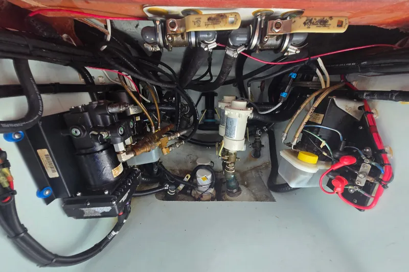 Slide: The Image of Engine compartment of a 2019 Contender 30 ST boat, showcasing complex wiring and components. - 80