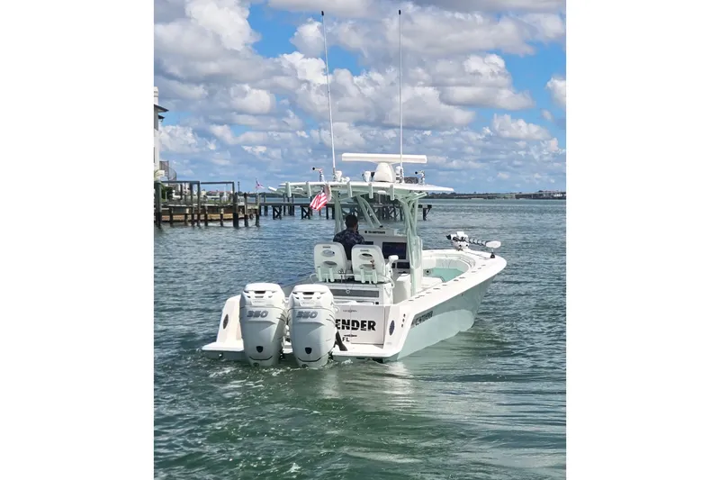 Slide: The Image of 2019 Contender 30 ST boat with twin engines on a sunny day at the marina. - 12