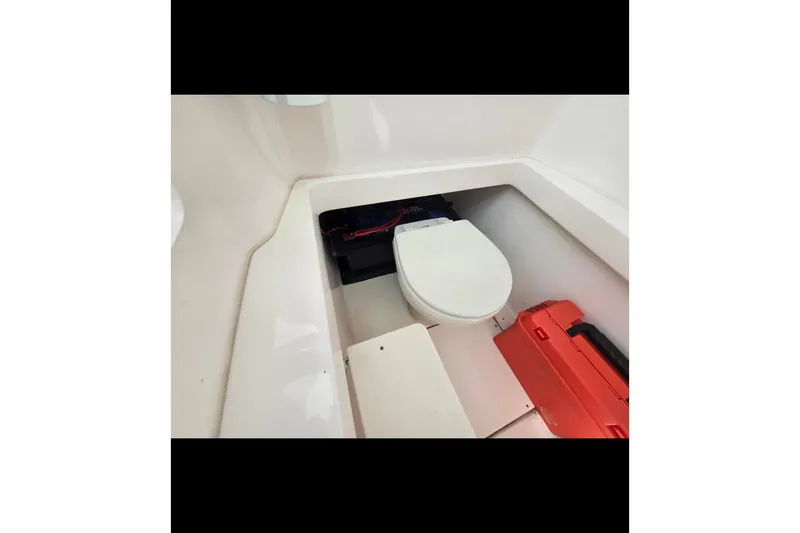 Slide: The Image of 2019 Contender 30 ST boat interior with toilet and storage compartment. - 69