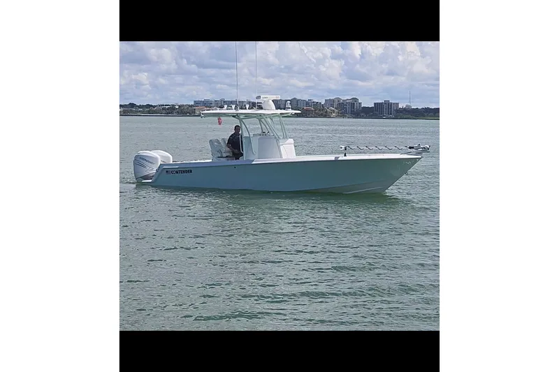 Slide: The Image of 2019 Contender 30 ST boat on calm water with city skyline in background. - 4