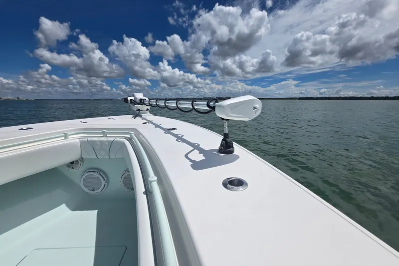 Slide: The Image of 2019 Contender 30 ST boat on calm water under a partly cloudy sky. - 62