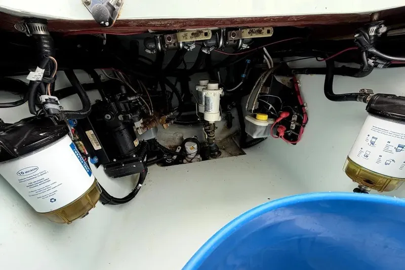 Slide: The Image of Engine compartment of a 2019 Contender 30 ST boat, showcasing fuel filters and wiring. - 21