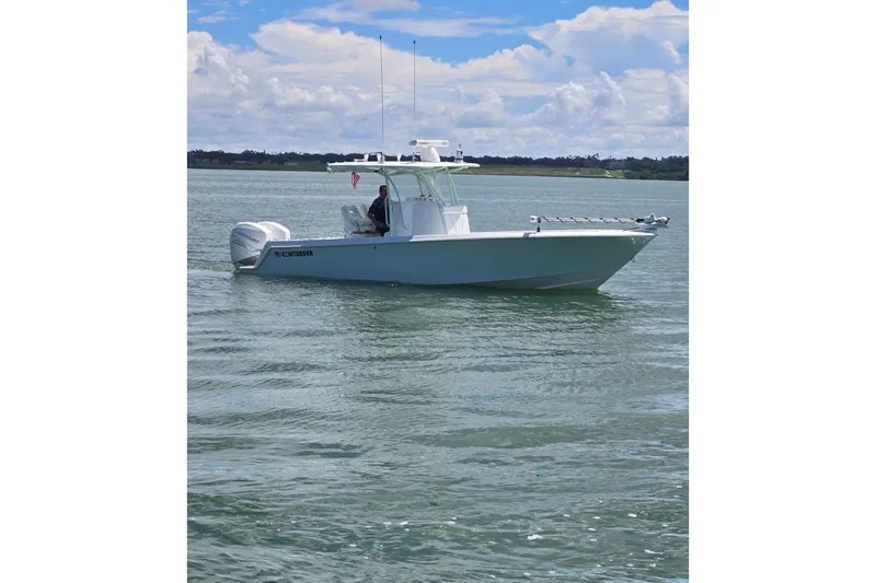 Slide: The Image of 2019 Contender 30 ST boat on calm water under a partly cloudy sky. - 3