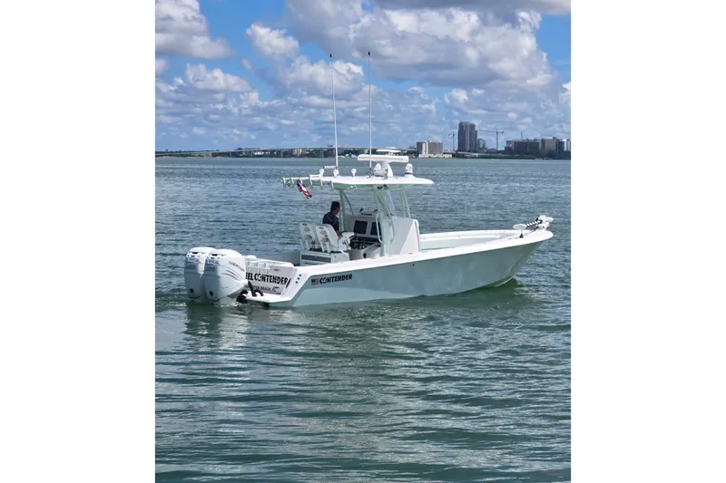 Slide: The Image of 2019 Contender 30 ST boat on calm water with city skyline in background. - 13