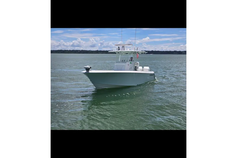 Slide: The Image of 2019 Contender 30 ST boat on calm water under a clear sky. - 8