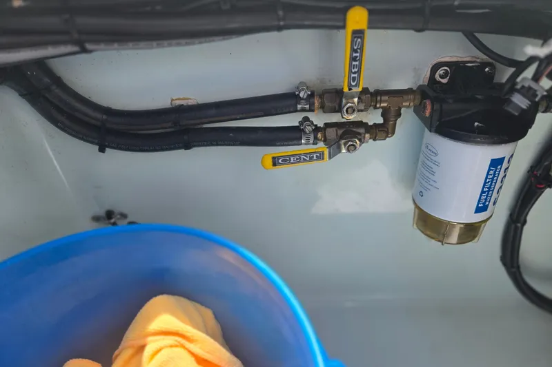 Slide: The Image of Fuel filter system in a 2019 Contender 30 ST boat, with hoses and valves visible. - 77