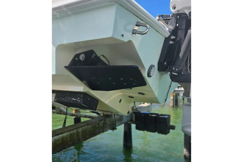 Slide: The Image of 2019 Contender 30 ST boat stern with trim tabs and motor mount in marina. - 22