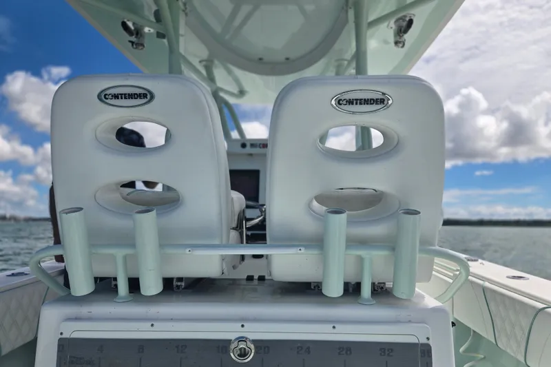 Slide: The Image of 2019 Contender 30 ST boat seats with rod holders, ocean view in background. - 52