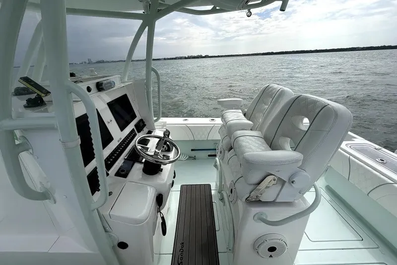 Slide: The Image of 2019 Contender 30 ST boat interior with helm, seats, and ocean view. - 8
