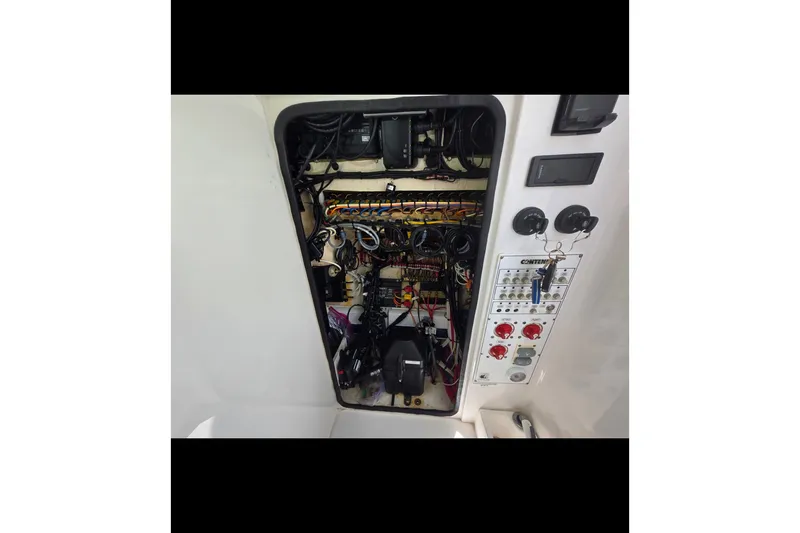 Slide: The Image of Electrical panel of a 2019 Contender 30 ST boat, showcasing wiring and controls. - 72