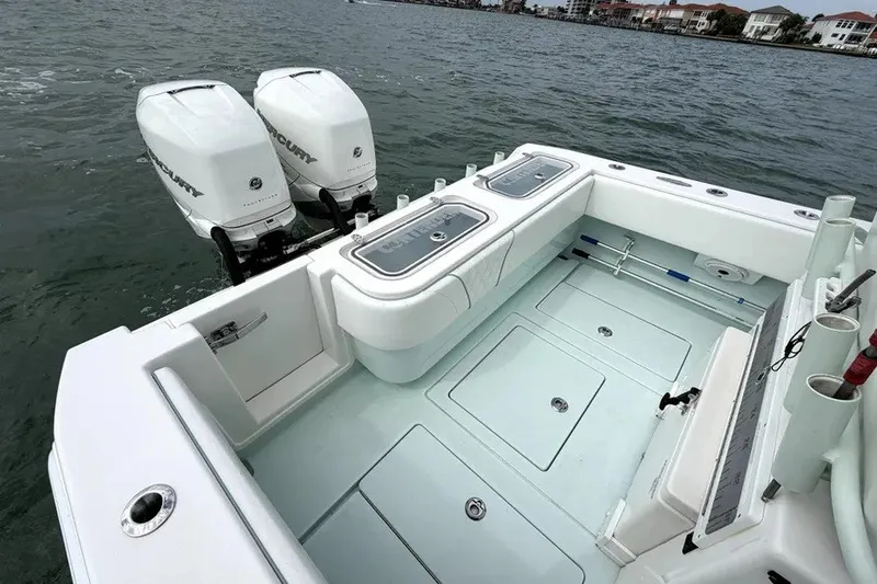 Slide: The Image of 2019 Contender 30 ST boat with dual Mercury engines on calm water. - 13