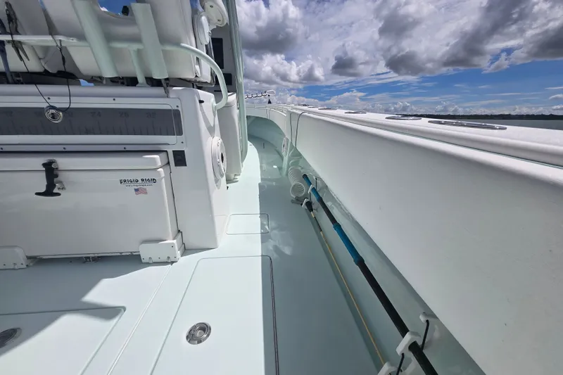 Slide: The Image of 2019 Contender 30 ST boat deck with storage and fishing equipment under a cloudy sky. - 54