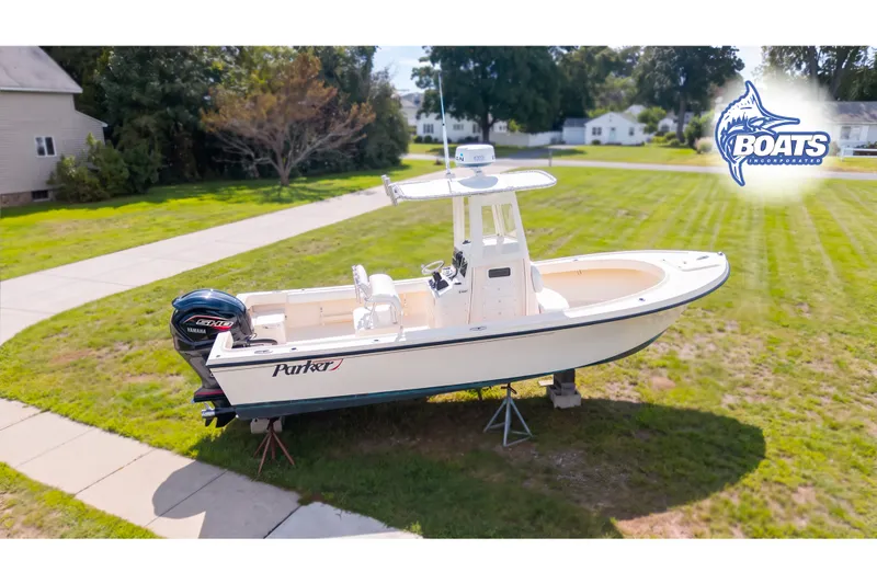 Slide: The Image of 2013 Parker 2300 Special Edition boat on display in a grassy yard. - 1
