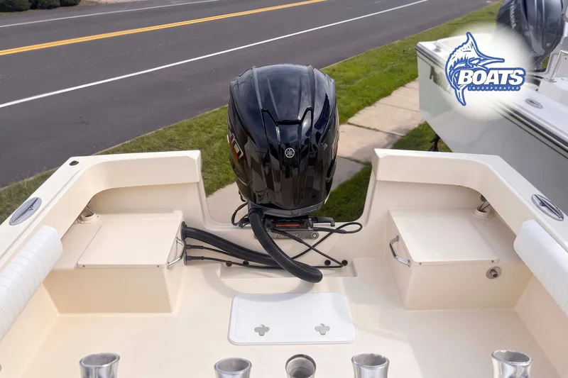 Slide: The Image of 2013 Parker 2300 Special Edition boat with Yamaha outboard motor, parked near a road. - 9