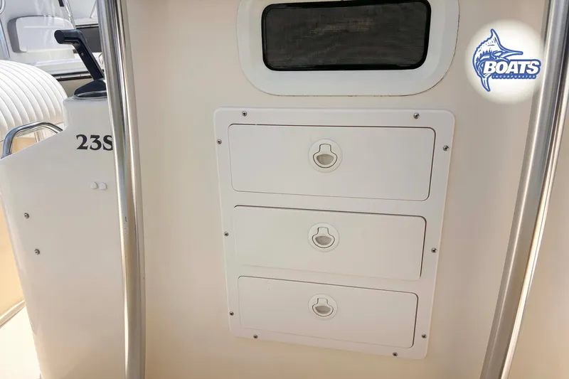 Slide: The Image of 2013 Parker 2300 Special Edition boat interior with storage compartments and seating. - 5