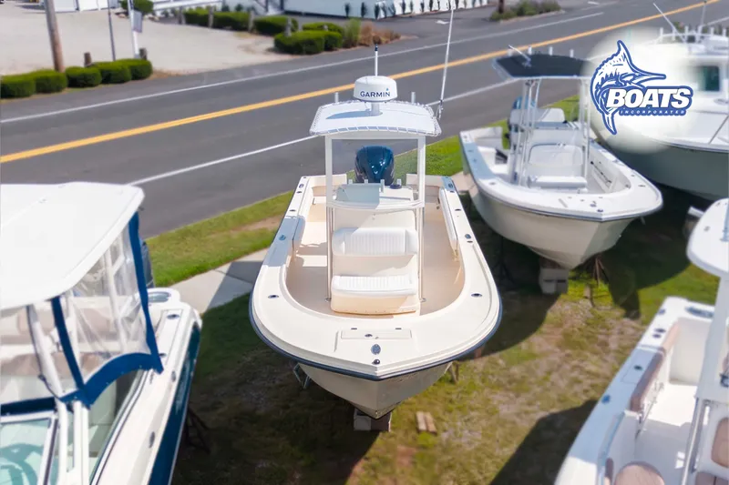 Slide: The Image of 2013 Parker 2300 Special Edition boat displayed outdoors with other boats nearby. - 2