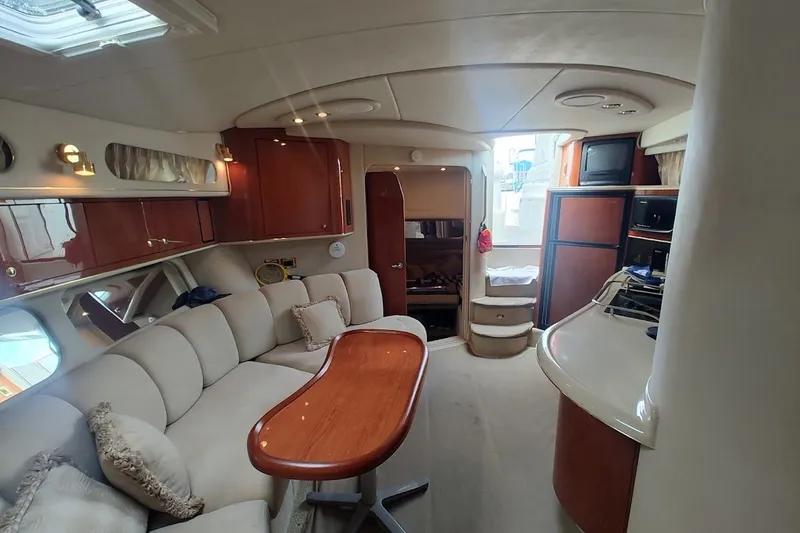 Slide: The Image of Luxurious interior of 2000 Sea Ray Sundancer 400 yacht with plush seating and wooden accents. - 25