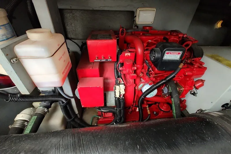 Slide: The Image of Engine compartment of a 2000 Sea Ray Sundancer 400, featuring a red marine engine. - 35