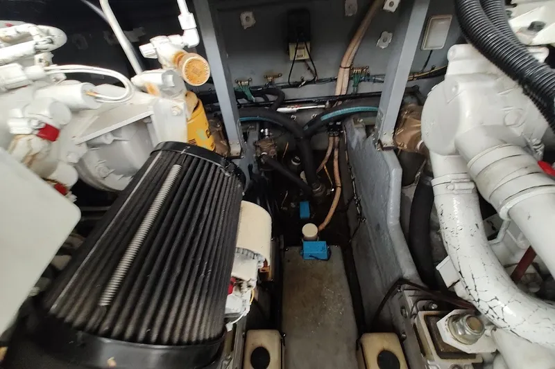 Slide: The Image of Engine compartment of a 2000 Sea Ray Sundancer 400, showcasing mechanical components and wiring. - 36