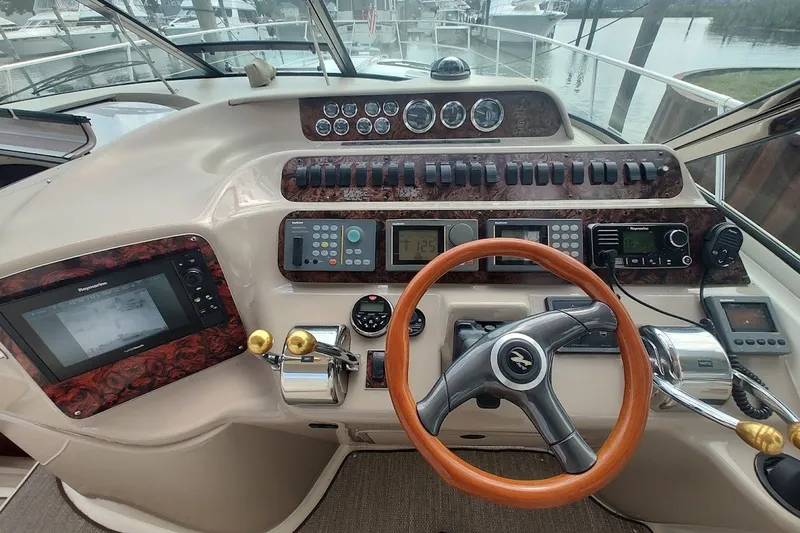 Slide: The Image of Cockpit of 2000 Sea Ray Sundancer 400 with steering wheel and navigation controls. - 14