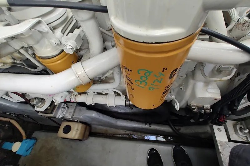 Slide: The Image of Engine compartment of a 2000 Sea Ray Sundancer 400 with visible oil filter and piping. - 31