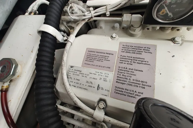 Slide: The Image of Engine compartment of a 2000 Sea Ray Sundancer 400 with Caterpillar service information. - 34