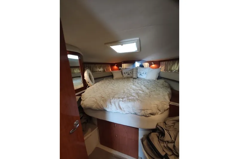 Slide: The Image of Cozy cabin interior of 2000 Sea Ray Sundancer 400 with plush bedding and soft lighting. - 22