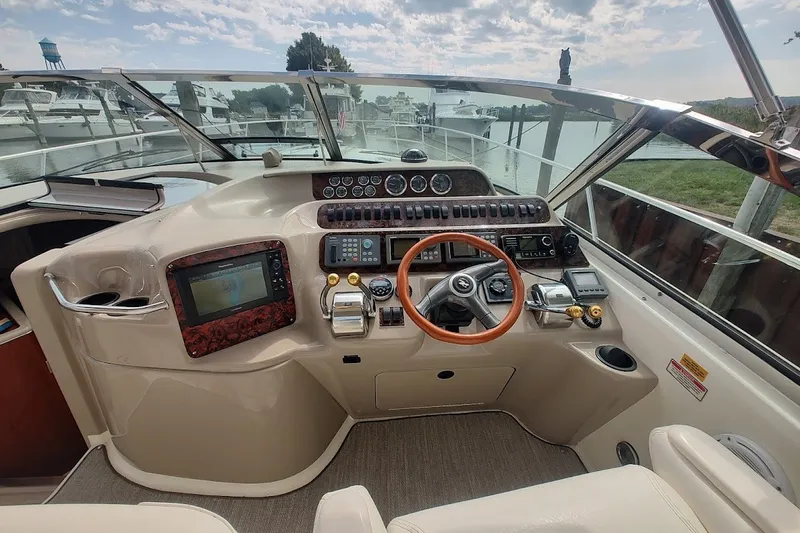 Slide: The Image of Cockpit of 2000 Sea Ray Sundancer 400 yacht with steering wheel and navigation controls. - 15