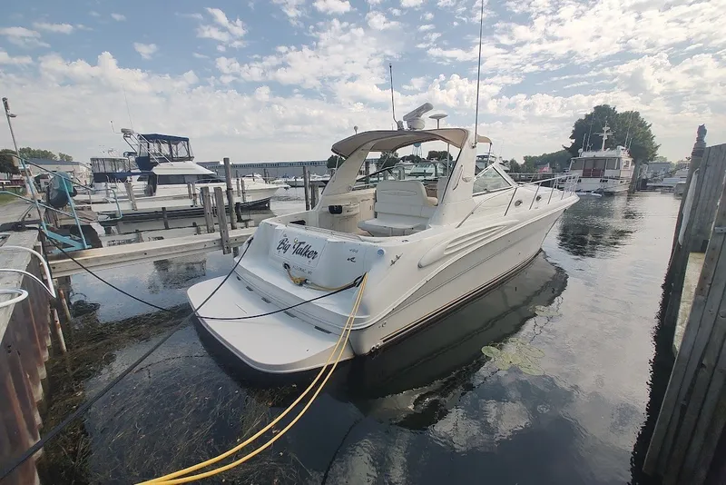 The Image of Sea Ray Sundancer 400 yacht docked at marina, 2000 model, under a partly cloudy sky. - 2