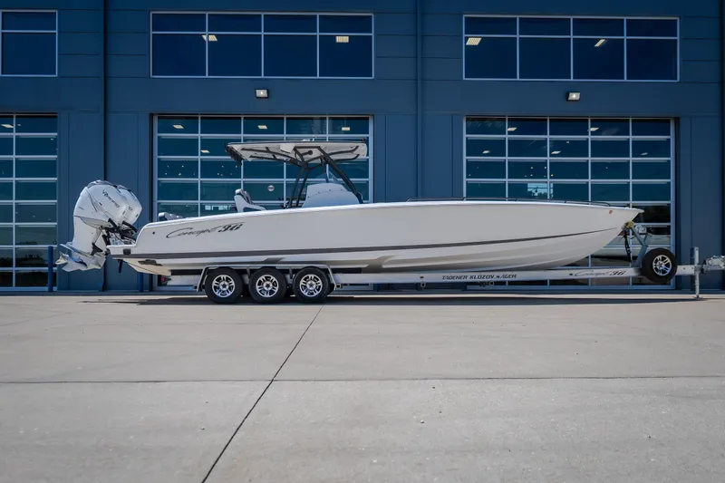 The Image of 2019 Concept 36' Cuddy Cabin boat on trailer, parked outside modern building. - 1