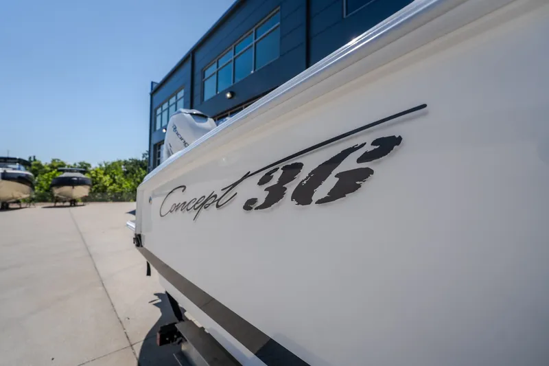 Slide: The Image of 2019 Concept 36' Cuddy Cabin boat exterior with logo, parked near a modern building. - 14
