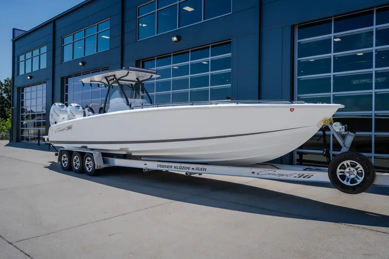 Slide: The Image of 2019 Concept 36' Cuddy Cabin boat on trailer outside modern building. - 2