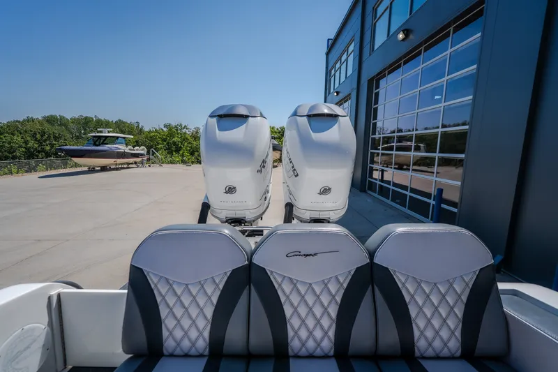 Slide: The Image of 2019 Concept 36' Cuddy Cabin boat with dual engines, parked near a modern building. - 40