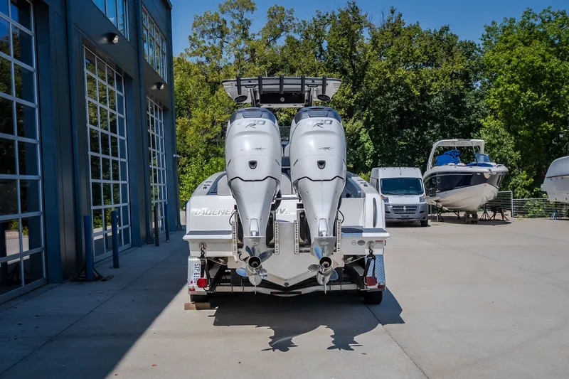 Slide: The Image of 2019 Concept 36' Cuddy Cabin boat with dual outboard engines, parked outdoors. - 18