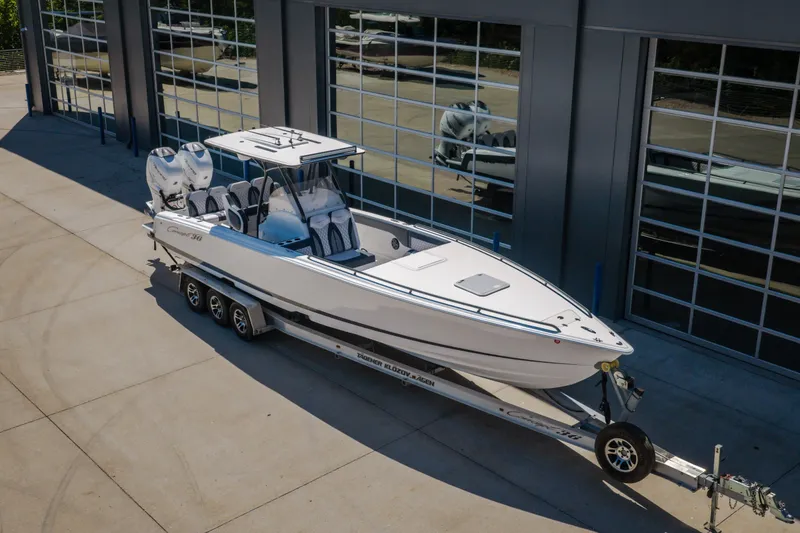 Slide: The Image of 2019 Concept 36' Cuddy Cabin boat on trailer, parked outside a modern garage. - 51