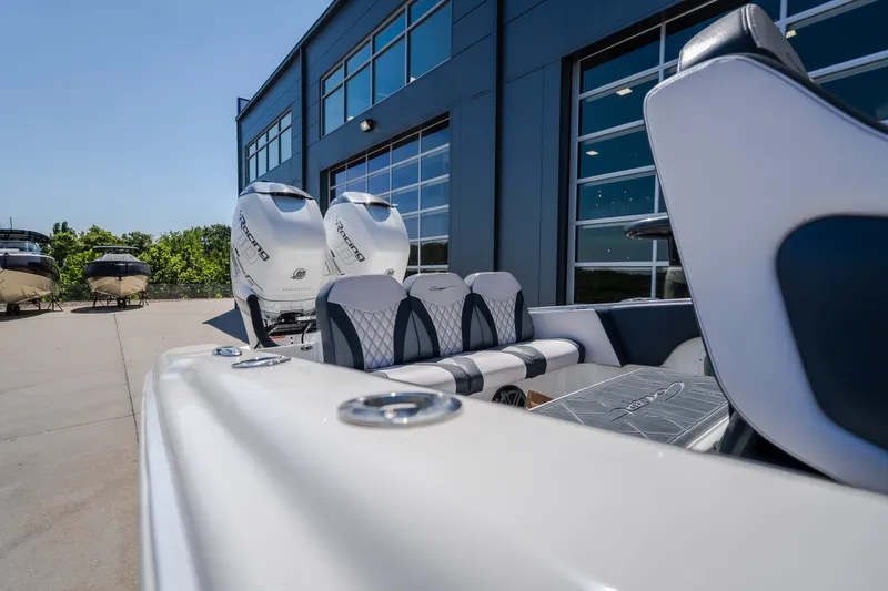 Slide: The Image of 2019 Concept 36' Cuddy Cabin boat with dual engines, parked near a modern building. - 15