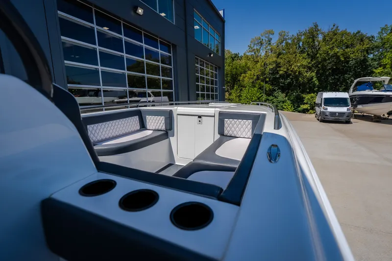 Slide: The Image of 2019 Concept 36' Cuddy Cabin boat with sleek seating, docked near a modern building. - 38
