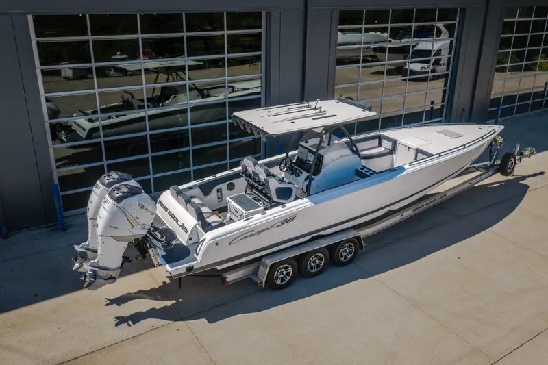 Slide: The Image of 2019 Concept 36' Cuddy Cabin boat on trailer, parked outside a garage. - 54