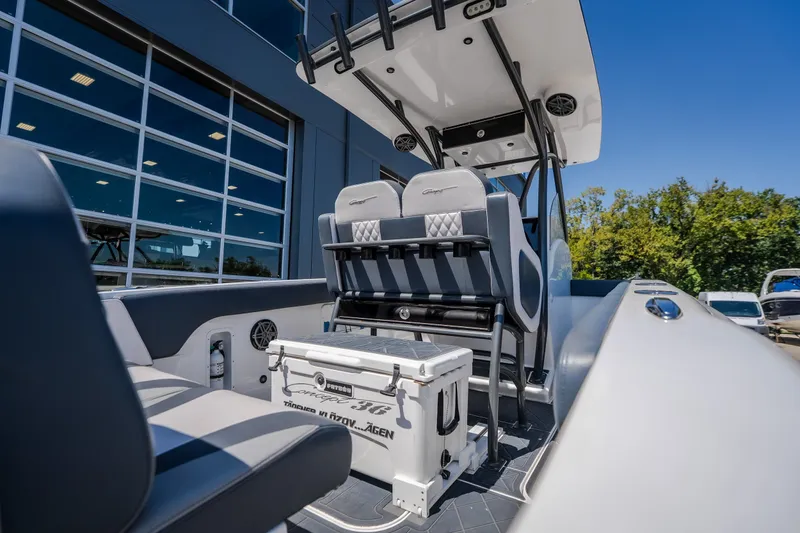 Slide: The Image of 2019 Concept 36' Cuddy Cabin boat interior with seating and storage, docked outdoors. - 44