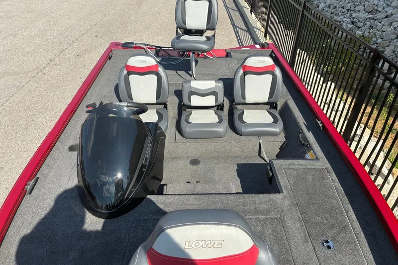 Slide: The Image of 2019 Lowe Stinger 175C boat interior with seating and steering console. - 15