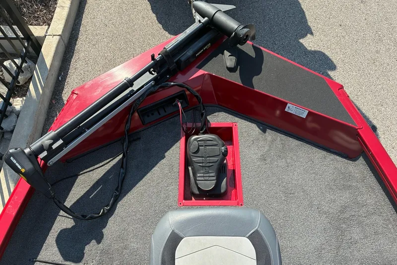 Slide: The Image of 2019 Lowe Stinger 175C boat with trolling motor and foot pedal on red deck. - 14