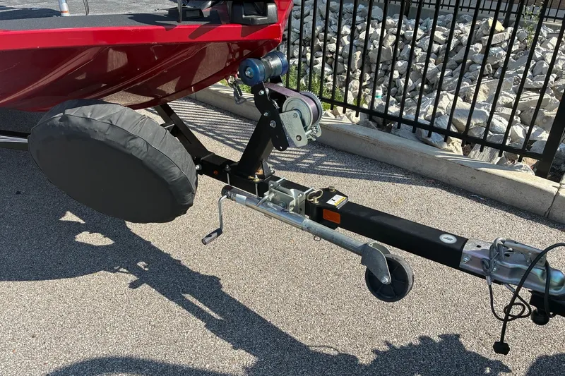 Slide: The Image of 2019 Lowe Stinger 175C boat trailer with winch and covered wheel on pavement. - 10