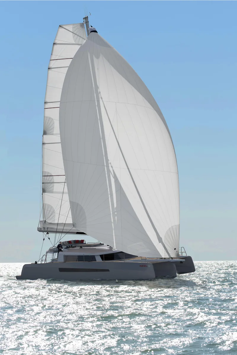 Slide: The Image of 2025 NEEL 52 trimaran sailing on open sea with full sails under clear blue sky. - 19