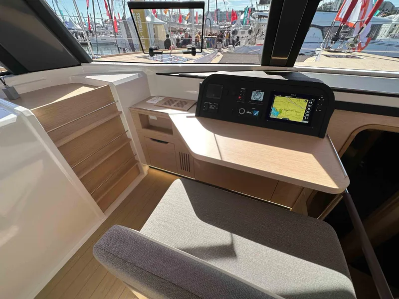 Slide: The Image of Modern NEEL 52 yacht interior with navigation system, wooden desk, and comfortable seating, 2025 model. - 17