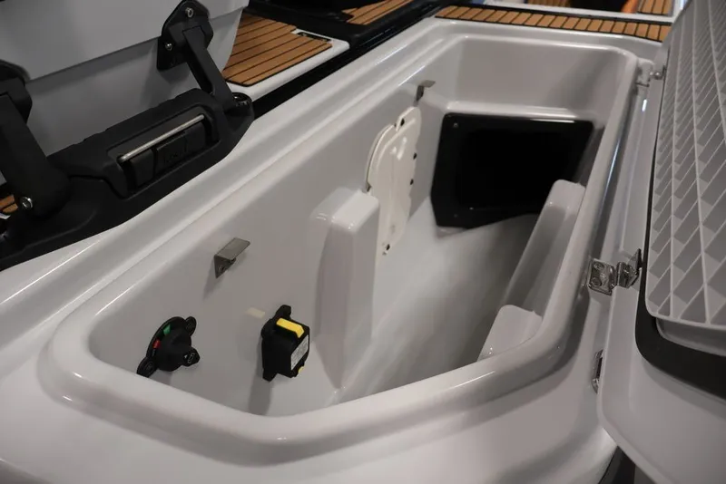 Slide: The Image of 2027 Yamaha WaveRunner Crosswave storage compartment with open lid and control panel. - 19