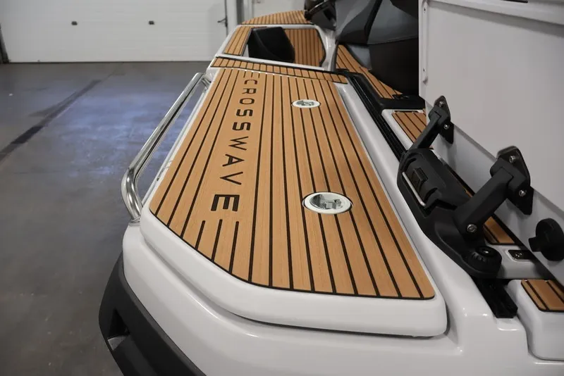 Slide: The Image of 2027 Yamaha WaveRunner Crosswave with sleek wooden deck design in a garage setting. - 11
