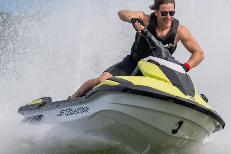 Slide: The Image of Man riding 2027 Yamaha WaveRunner JetBlaster on water, creating a splash. - 2