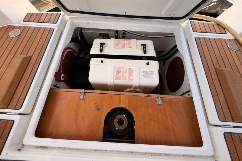 Slide: The Image of Engine compartment of a 2014 Jeanneau Sun Odyssey 509 sailboat, featuring wooden panels. - 105