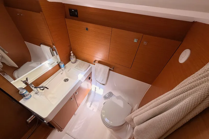 Slide: The Image of Luxurious bathroom in 2014 Jeanneau Sun Odyssey 509 yacht, featuring modern fixtures and wooden cabinetry. - 91