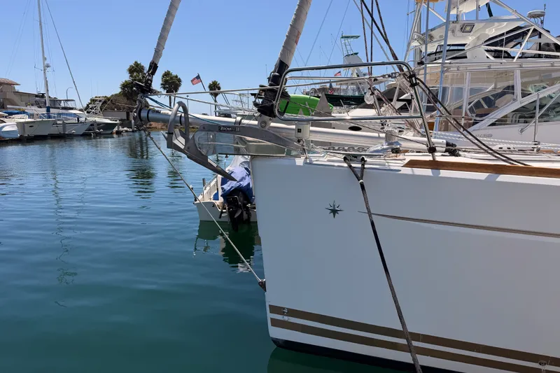 Slide: The Image of 2014 Jeanneau Sun Odyssey 509 yacht docked in a marina, featuring sleek design and modern rigging. - 7